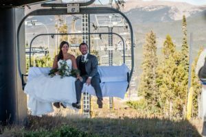 Bride and Groom ride up the Zephyr Lift at Winter Park Resort for a wedding at Sunspot