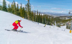 Skier in a red onesie costume rides at Winter Park Resort for Gaper Day